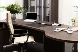 18233301 – laptop and flowers on the table in a modern office alternate text for this image