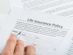 Hand Filling Life Insurance Policy