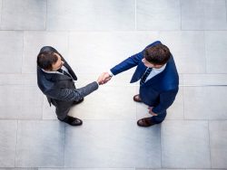 Overhead view of young business men shaking hands