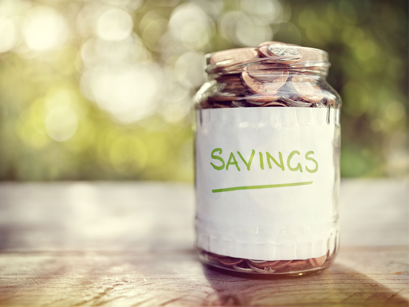Savings money jar full of coins concept for saving or investment for a house, retirement or education