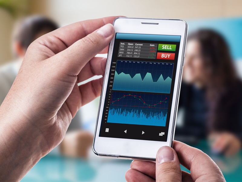 smart phone running a trading or forex app with charts and data