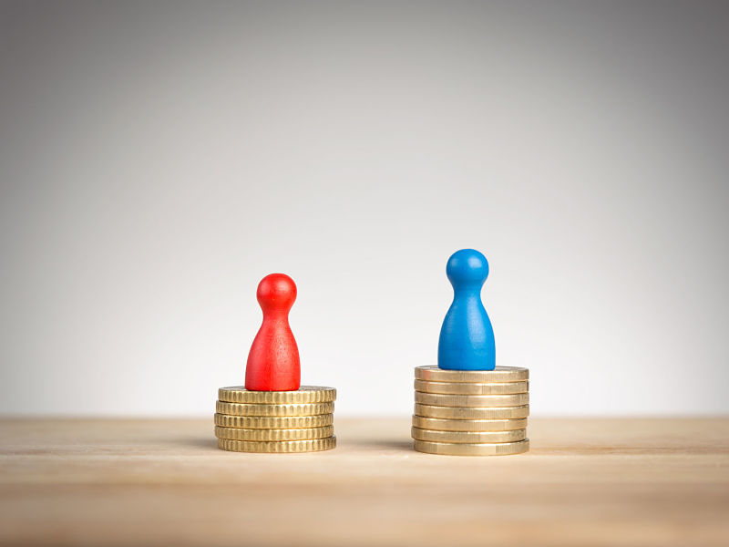 wage gap concept, blue figure symbolizing men and red pawn women,