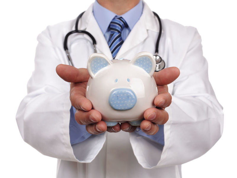 Doctor holding piggy bank