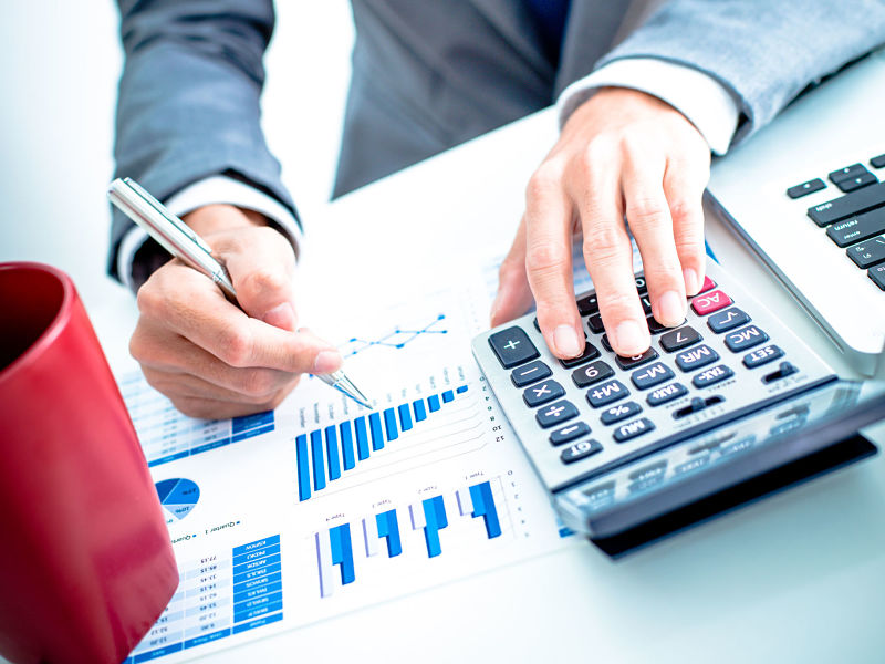 usinessman analyzing investment charts with laptop