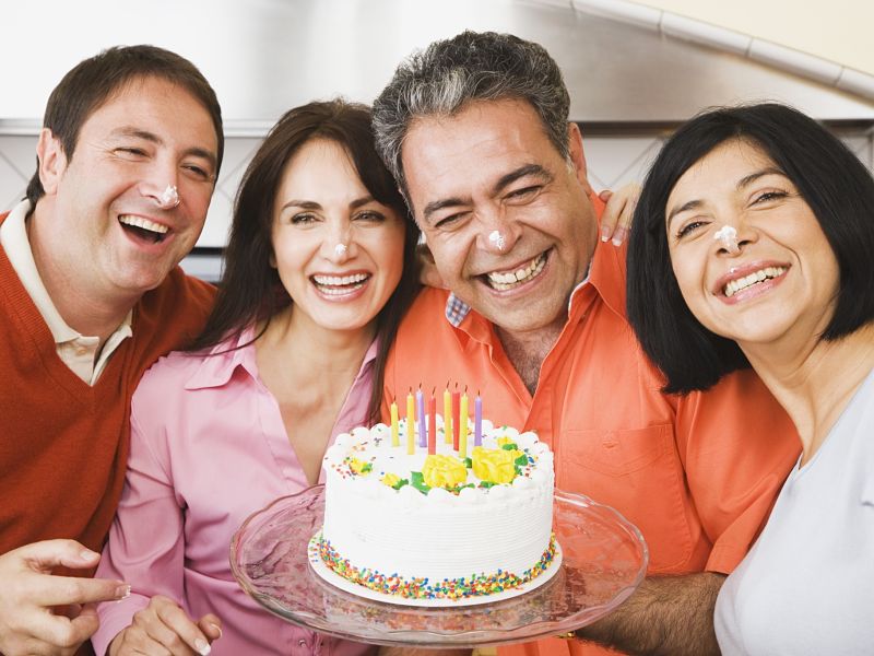 middle-aged man celebrating birthday with friends