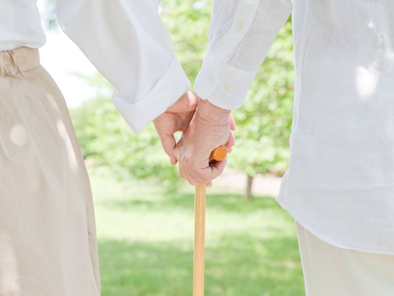 elderly couple who grips cane