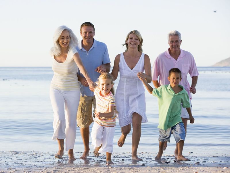 extended family walking on beach