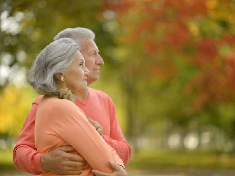 Beautiful caucasian elderly couple in the park in autumn