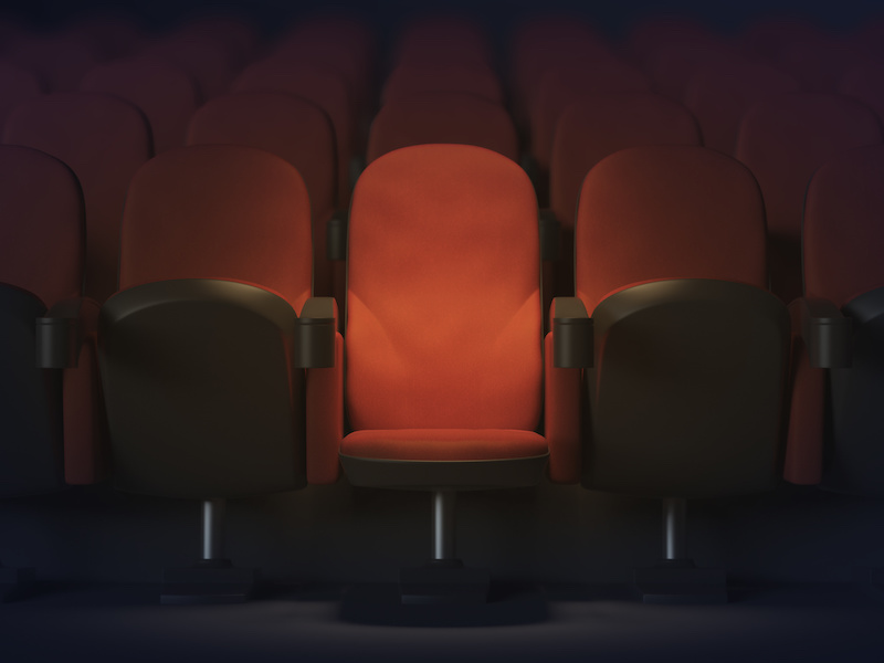 Close up of illuminated red movie theater armchair. Show concept. 3D Rendering