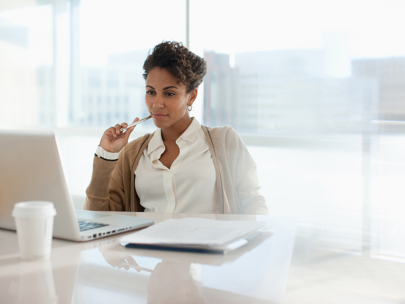 Businesswoman using laptop in office