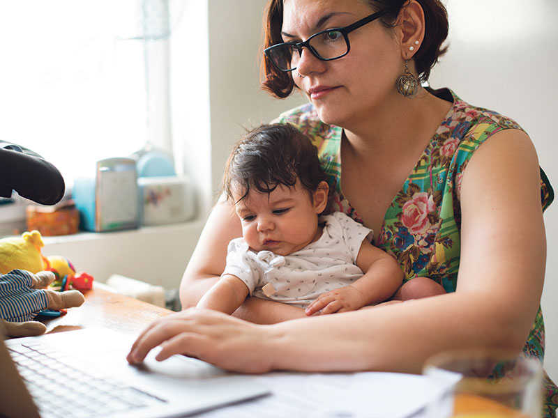 woman working from home with baby