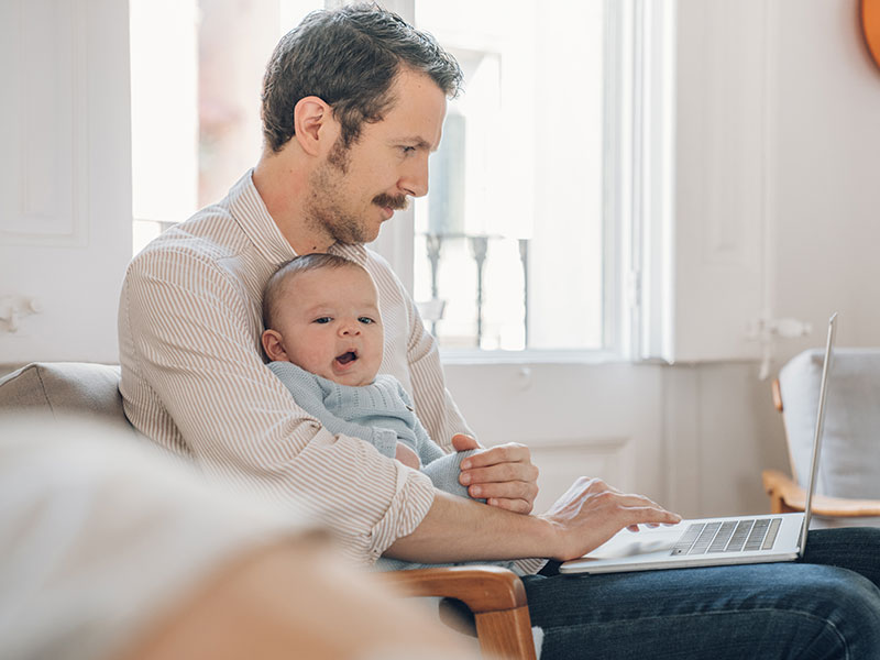 man working from home with baby