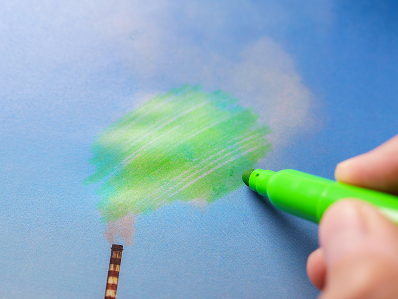 Man painting pollution green