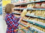 Woman with package pasta in shop stock photo