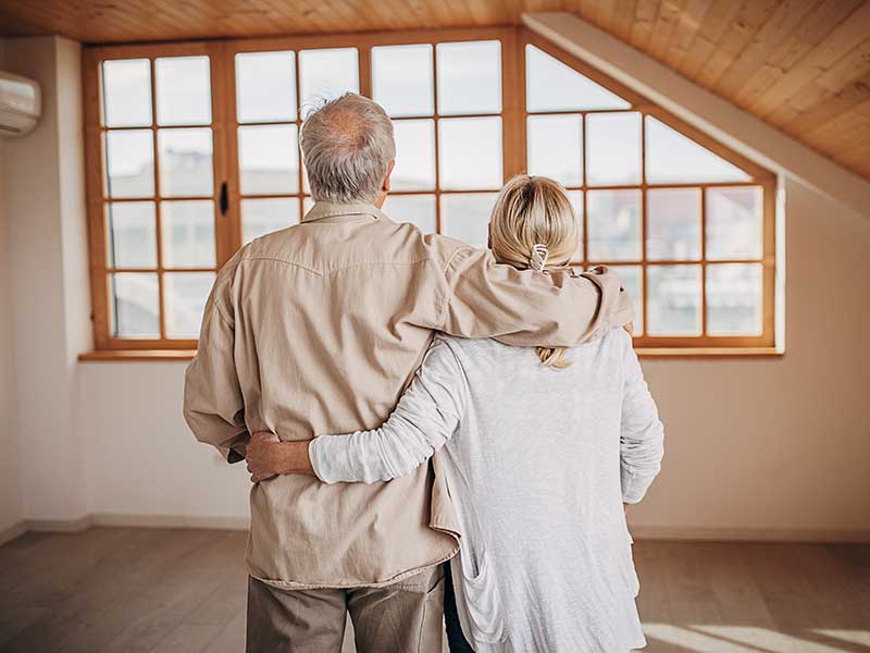 Two people, senior married couple in their empty apartment.