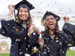 students celebrating on graduation day stock photo