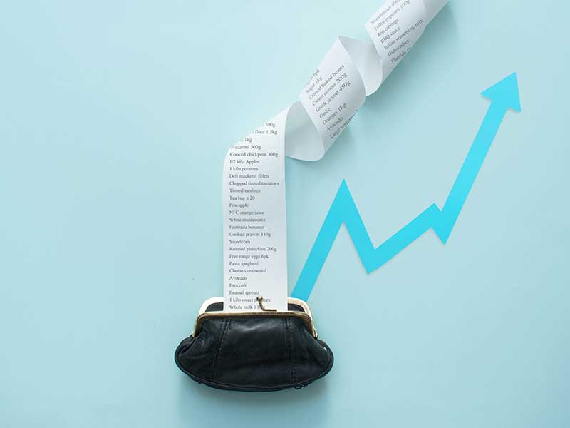 Coin purse with a receipt and an arrow trending upward, concept of inflation