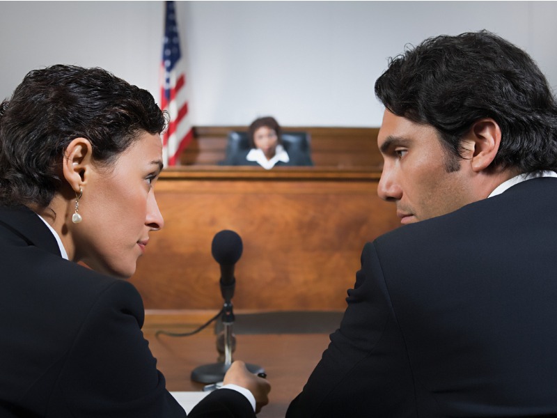 A lawyer and defendant talking stock photo