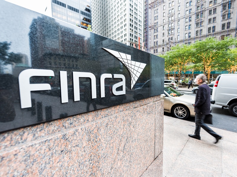 Sign on the building of Financial Industry Regulatory Authority, or Finra, in Manhattan NYC lower financial district downtown, businessman man walking stock photo