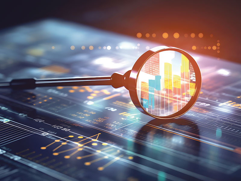 Magnifying glass looking at financial data