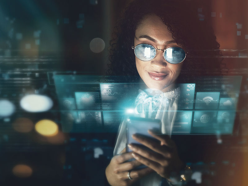 woman with glasses looking at a phone