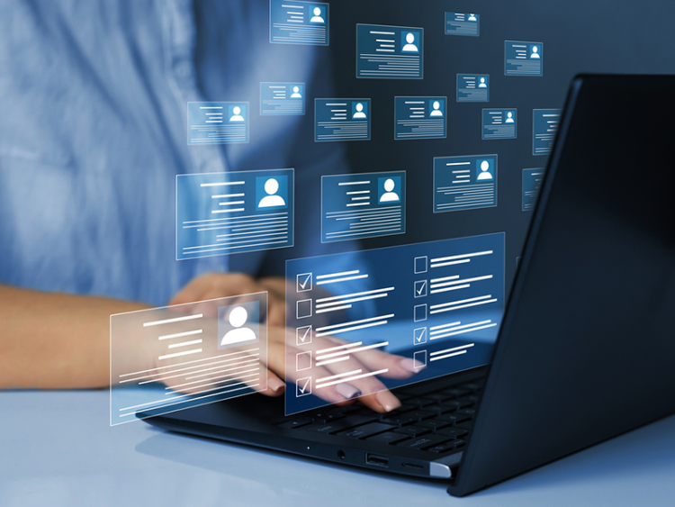 Person typing on a laptop with floating digital profile cards and checklist icons representing online forms, data management, or digital identity verification.